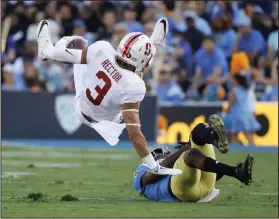  ?? AP PHOTO ?? Stanford wide receiver Michael Rector is tackled by UCLA defensive back Jaleel Wadood.