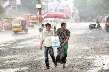  ??  ?? A woman and a boy walk under an umbrella during heavy rains in Nagercoil, Tamil Nadu