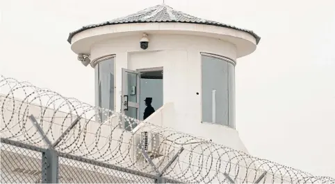  ??  ?? A guard stands in a watchtower of Kashgar prison in Xinjiang. Beijing dismisses accusation­s of genocide and forced labour in the western province.