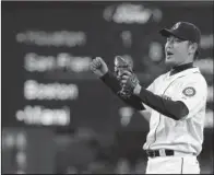  ??  ?? MERRY MARINER: Seattle’s Hisashi Iwakuma joins Hideo Nomo as the only Japanese- born pitchers to throw a no- hitter. Here, Iwakuma reacts after the final out against the visiting Baltimore Orioles Wednesday.