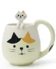  ??  ?? Cats are a popular motif in Asian tableware, symbolizin­g good luck. This mug comes with its own little kitten spoon.