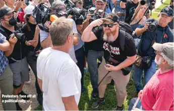  ?? AP ?? Protesters face off at a political rally.