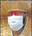  ?? AFP ?? An indigenous man in a mask at a rally in Brasilia, Brazil.