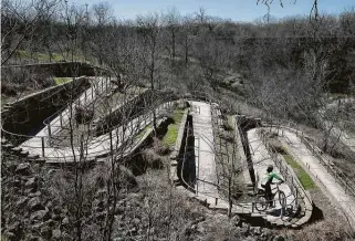  ?? Lisa Krantz / Staff photograph­er ?? Trail steward Carlos Prado rides on the Medina River Greenway, part of the city of San Antonio’s hike-and-bike trail system, on Tuesday. About 70 miles of trails have been built since 2000.