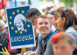  ??  ?? The people have spoken: A man holds a placard outside Downing Street, the PM’s residence.