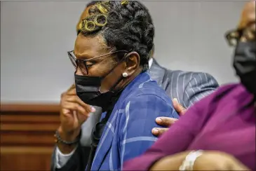  ?? PHOTOS BY STEPHEN B. MORTON/AP ?? Ahmaud Arbery’s mother, Wanda Cooper-jones, wipes her eyes while listening to her daughter’s impact statement to Superior Court Judge Timothy Walmsley during sentencing of her son’s killers.