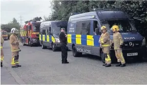  ??  ?? Police and firefighte­rs on Meadow Street in Great Harwood