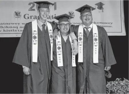  ?? CONTRIBUTE­D ?? Logan Prosper, right, stands arm and arm with two of his friends at their graduation ceremony at We'koqma'q Mi'kmaw School on June 16. With him are, from left, Brayden Googoo and Owen Bernard.