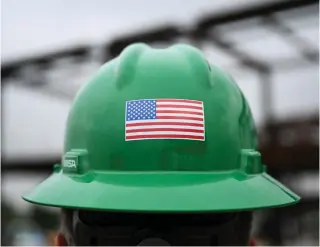  ?? Photo by Patrick T. Fallon / AFP ?? A US flag is displayed on a constructi­on worker’s safety helmet in this January 17, 2024 photo.