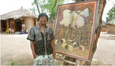  ??  ?? Ikenna Udeh alias Buffalo next to one of his works shortly before he fell ill