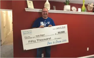  ??  ?? Grand Prize winner Dale Nagel collecting his $50,000 award