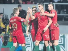  ?? AFP ?? Portugal forward Andre Silva, centre, celebrates with teammates after scoring against Poland at the Dom Alfonso Henriques Stadium in Guimaraes.