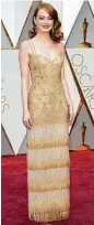  ??  ?? Emma Stone shimmers in a fringed Givenchy gown.