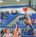  ?? Steven Eckhoff ?? Unity Christian’s Hudson Hill leaps up for a basket during a game against the Model Blue Devils at Model High School on Jan. 4.