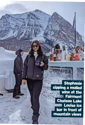  ??  ?? Stephanie sipping a mulled wine at the Fairmont Chateau Lake Louise ice bar in front of mountain views