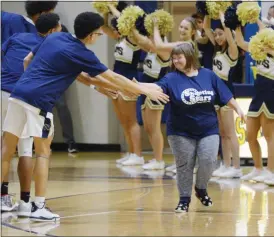  ?? OWEN MCCUE - MEDIANEWS GROUP ?? Shooting Stars player Amanda Kopisecki is greeted by Spring-Ford players as she is introduced before a Dec. 14 Spring-Ford and Pope John Paul II boys basketball game.