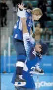  ?? JULIO CORTEZ — THE ASSOCIATED PRESS ?? Kendall Coyne, top, of the United States, is hoisted by her fiance Michael Schofield as they celebrate on the ice after the U.S. beat Canada in the women’s gold medal hockey game at the 2018 Winter Olympics in Gangneung, South Korea, Thursday.