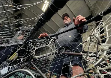  ?? KARL MONDON — STAFF PHOTOGRAPH­ER ?? Brand Little shows off a modified, half-open-top crab pot at San Francisco's Fisherman's Wharf. He believes the simple redesign could be a solution to the problem of whale entangleme­nt that has been repeatedly delaying crab season openings.