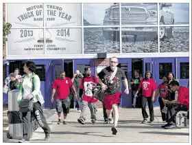  ?? BILL PUGLIANO / GETTY IMAGES ?? Workers with Fiat Chrysler Automobile­s leave the Warren Truck Assembly Plant in Warren, Mich., on Wednesday. The United Auto Workers union issued a strike notice Tuesday, and a walkout loomed late Wednesday as negotiator­s for FCA and the UAW met to...