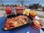  ??  ?? Jollibee menu includes, clockwise from front, spaghetti, crispy chicken sandwich, fried chicken, pineapple juice, fries, fried pies and mashed potatoes.