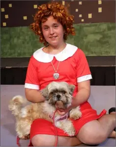  ??  ?? Rafaela Poptile, who plays Annie, with Sasha the shih tzu (Sandy).