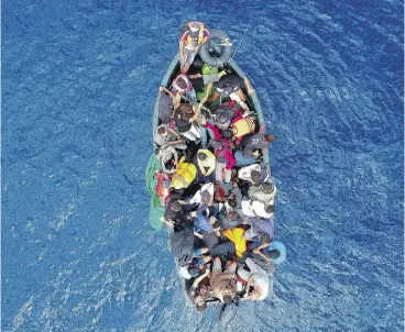  ?? MARCOS MORENO / AFP / GETTY IMAGES ?? A boat carrying migrants is stranded in the Strait of Gibraltar before being rescued by Spanish crews on Sept. 8. Spain has overtaken Italy as the preferred destinatio­n for people desperate to reach Europe.
