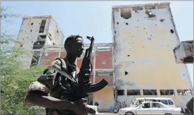  ?? FEISAL OMAR/ REUTERS ?? A Somali government soldier patrols Mogadishu. Somali faction leaders have gathered for a conference in London.