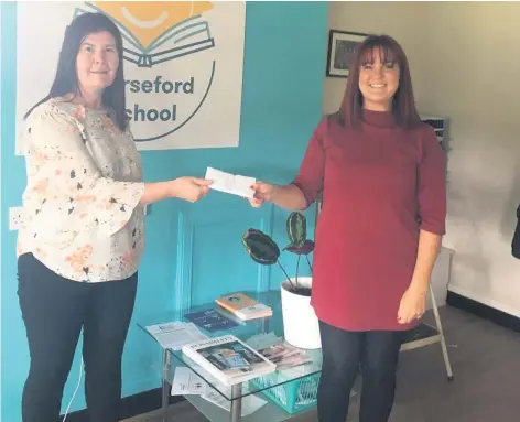  ??  ?? Lovely gesture Shop assistant Alison hands over the cheque to Lynn Reynolds from Corseford School