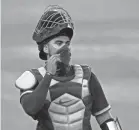  ?? TONY GUTIERREZ/AP ?? Rangers catcher Robinson Chirinos adjusts his mask during a recent workout.