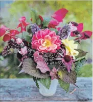  ??  ?? An impromptu bouquet from the November garden includes dahlia, butterfly bush, pink shrub roses, burning bush, hydrangea, lemon balm and sedum Matrona.