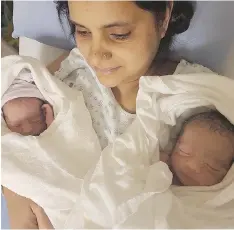  ??  ?? Meena Devi holds her twin sons, born Monday at Victoria General Hospital. Their father Khushal Rana died Oct. 21, three days after he was hit by an SUV while walking to work. The family has another son, four-year-old Ankush.