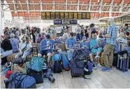  ?? Ashlee Ruggels/Associated Press ?? Passengers wait as train services continue to be disrupted after a one-day strike by the Rail, Maritime and Transport union.