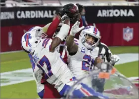  ?? AP PHOTO/ROSS D FRANKLIN ?? Arizona Cardinals wide receiver DeAndre Hopkins catches the game-winning touchdown as Buffalo Bills cornerback Tre’Davious White (27), free safety Jordan Poyer (21) and strong safety Micah Hyde, left, defend during the second half of an NFL football game, Sunday, Nov. 15, in Glendale, Ariz. The Cardinals won 32-20.