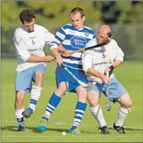  ?? Photo: Neil Paterson ?? Skye’s Stewart Grant and Kenny Campbell deal with Newtonmore’s David MacLean during the Camanachd Cup sem-final.