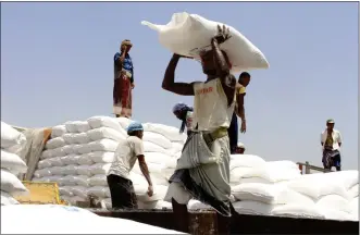  ?? HAMMADI ISSA — THE ASSOCIATED PRESS, FILE ?? Men deliver U.N. World Food Program (WFP) aid in Aslam, Hajjah, Yemen in September 2018. The World Food Program on Friday, Oct. 9, 2020 won the 2020 Nobel Peace Prize for its efforts to combat hunger and food insecurity around the globe.