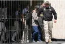  ?? Photograph: Martín Mejía/AP ?? Police escort Nicanor Boluarte out of his home in Lima.