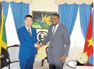  ?? CONTRIBUTE­D ?? Minister without portfolio in the Office of the Prime Minister with responsibi­lity for informatio­n, Robert Morgan (right), shakes hands with Ambassador of the People’s Republic of China to Jamaica, Chen Daojiang, during a courtesy call at Jamaica House on August 3.