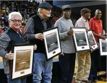  ?? Michael Wyke ?? UH team members from the Game of the Century 50 years ago — a 71-69 upset of UCLA in the Astrodome — were honored during halftime of the Cougars’ stunning win over No. 7 Wichita State.