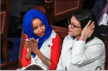  ??  ?? in this feb. 5 photo, rep. ilhan Omar, D-Minn. (left) joined at right by rep. rashida Tlaib, D-Mich., listens to President Donald Trump’s State of the Union speech, at the Capitol in Washington.AP PHOTO/J. ScOTT APPLEwHITE