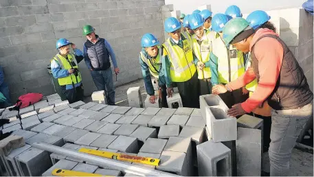  ?? Picture: AYANDA NDAMANE ?? ENCOURAGED: Engineerin­g students from St Andrew’s Technical High School in Elsies River were invited to the site of the National Home Builders Registrati­on Council to see operations.