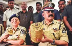  ?? PTI ?? Police Commission­er Anjani Kumar shows journalist­s the three-tier gold tiffin box, which had been stolen from Nizam’s Museum, in Hyderabad, yesterday.