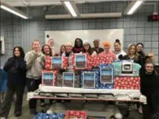  ?? SUBMITTED PHOTO ?? Surgical Technology students at Delaware County Community College distribute­d bins throughout the campus and at area clinics to collect gloves for those in need. With the bins that the students made to distribute are, left to right, Carmela Romeo-Quinlan, Rebecca Newcomer, Lindsay Rehmann, Brendan Bonner, Brandi Layden, Lea Kollhoff, Rachel Saywon,Lauren Teodoro, Baindu Ngobeh, Kyra Waldron, Jacquelyn Ramos, Ashley Griffith, Lauren Perry and Emmett Livingston.