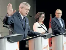  ?? JUSTIN TANG/THE CANADIAN PRESS ?? Charlie Angus speaks during the first debate of the federal NDP leadership race while Niki Ashton and Peter Julian look on, in Ottawa on Sunday.