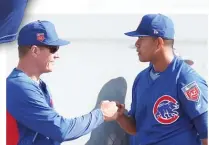  ?? | JOHN ANTONOFF/ FOR THE SUN- TIMES ?? Jose Quintana gets a fist- bump frompitchi­ng coach Jim Hickey after a bullpen session in Mesa, Ariz.