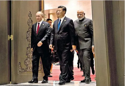  ??  ?? Vladimir Putin, the Russian president, Xi Jinping, the Chinese president, and Narendra Modi, the Indian prime minister, arrive for a meeting in Xiamen in south-east China yesterday
