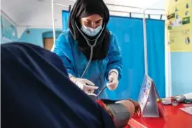  ?? SAVE THE CHILDREN VIA AP ?? A Save the Children midwife provides Zarmina, 25, who is five months pregnant, with a pre-natal checkup Oct. 2 in Jawzjan province in northern Afghanista­n.