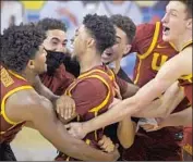  ?? Mark J. Terrill Associated Press ?? TAHJ EADDY, middle, sank the Bruins on March 6 with a similar shot and will get to play in the NCAAs.