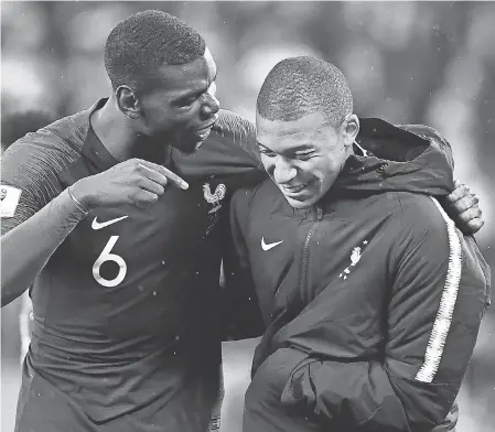  ?? FRANCK FIFE/AFP/GETTY IMAGES ?? Stars Paul Pogba (6) and Kylian Mbappe are on a French team in which 78.3 percent come from a migrant background.