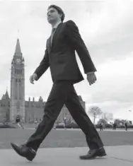  ??  ?? Prime minister-designate Justin Trudeau heads to a press conference on Parliament Hill in Ottawa on Oct. 20, a day after winning a stunning election victory.