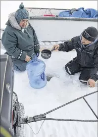  ?? CP PHOTO/HO-ALLAN GORDON ?? Karl Michelin and Kenneth “Hooker” Best collect drinking water near English River, N.L., in an undated handout photo. Researcher­s studying higher rates of gastrointe­stinal illness in Inuit communitie­s have a message for all Canadians: wash your water...